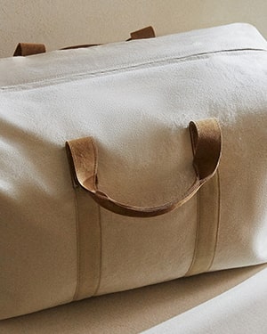 Beige duffel bag ,brown leather handles