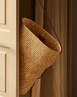 Straw hat on doorway hook sunlight, soft shadow